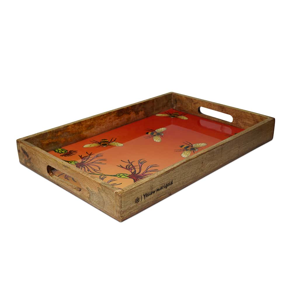 Close-up of Yellow Marigold Bees in Paradise Carrot tray showing artisan mango-wood grain, hand-painted bees and enamel finish for premium serveware.