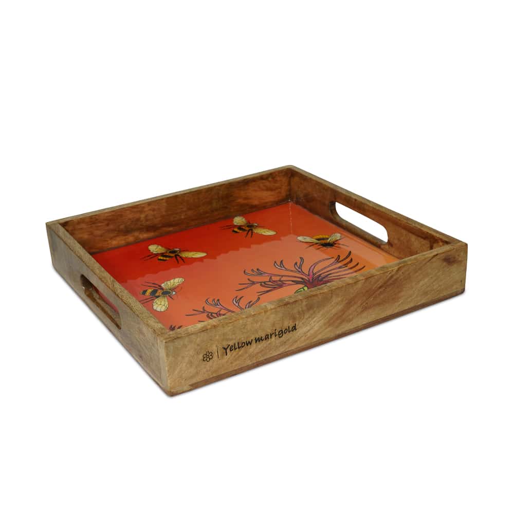 Close-up of Yellow Marigold Bees in Paradise Carrot tray showing artisan-crafted mango wood, enamel on wood finish and hand-painted botanical bees design