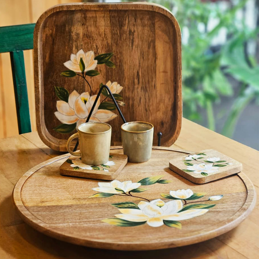 Handcrafted Yellow Marigold Handpainted Lazy Susan – Sweet Magnolias, artisan working on mango wood serveware with intricate magnolia pattern.