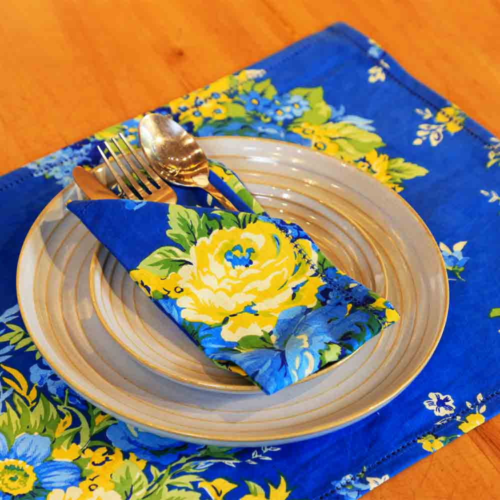 Yellow Marigold Avonlea Blue Table Napkins set of 6 — blue floral-print cotton napkins neatly folded