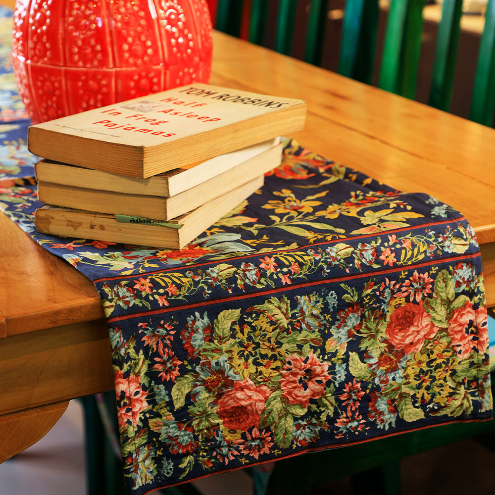 Yellow Marigold Eternal Rose Navy table runner draped over a wooden dining table with crockery and décor — elegant home dining ambience