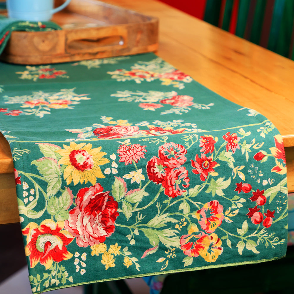 Yellow Marigold Russian Chintz Green table runner draped on a wooden dining table with crockery and décor — elegant home dining ambience