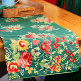 Yellow Marigold Russian Chintz Green table runner draped on a wooden dining table with crockery and décor — elegant home dining ambience