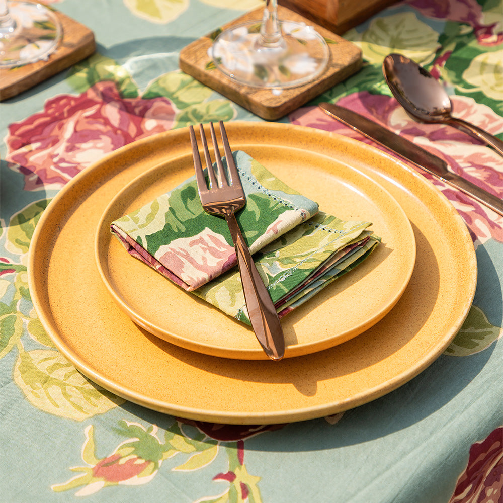 Artisan detail of Yellow Marigold Desert Sky dinner plate set: handcrafted porcelain, soft sky-blue hue, unique glaze finish per plate.