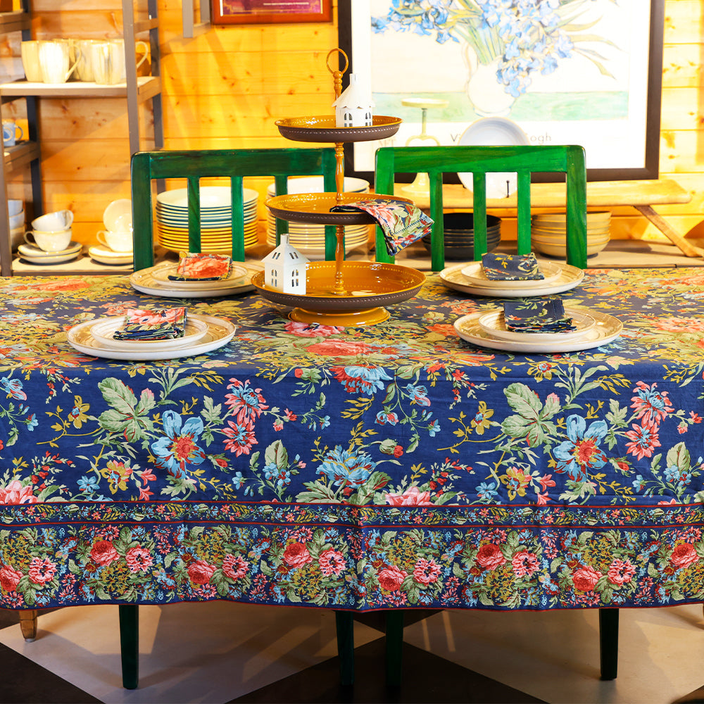 Yellow Marigold Eternal Rose Navy table cover draped over a wood dining table with crockery and décor — elegant home dining ambience